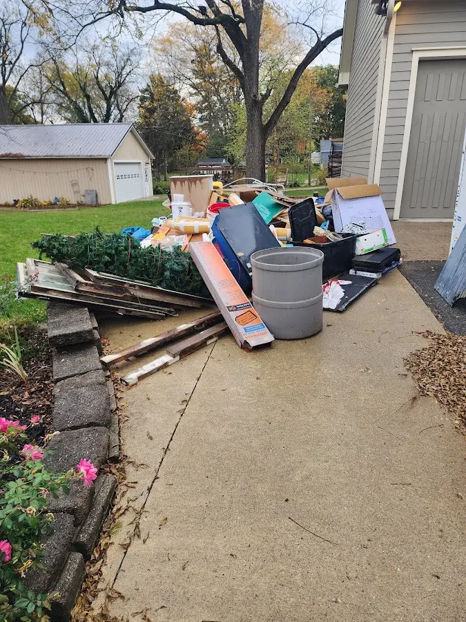 Dumpster being loaded with debris for Estate Cleanout Dumpster Rental in Wilmette